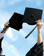 Graduates tossing mortarboards.